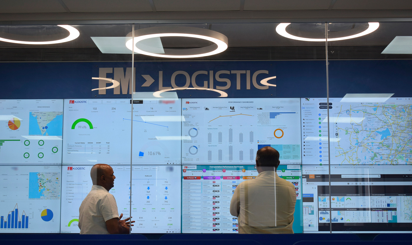 Logistics control tower displaying real-time supply chain dashboards in a central operations control room at FM Logistic. Desktop version of the picture.