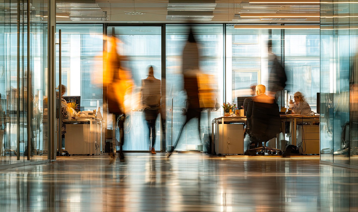 Employees working in a modern office, illustrating collaboration and strategic planning around full-service logistics for mid-sized businesses. Desktop version of the picture.